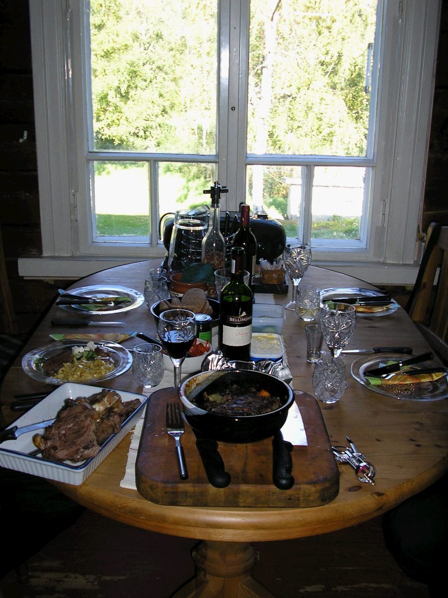 Dinner table set at the log cabin, autumn light through the window