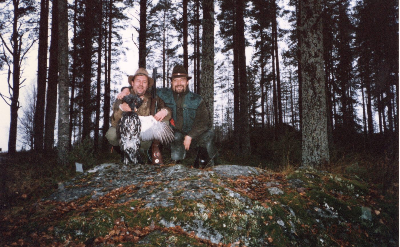 Two hunters with a capercaillie in the pine forest, Lieksa, October 1996
