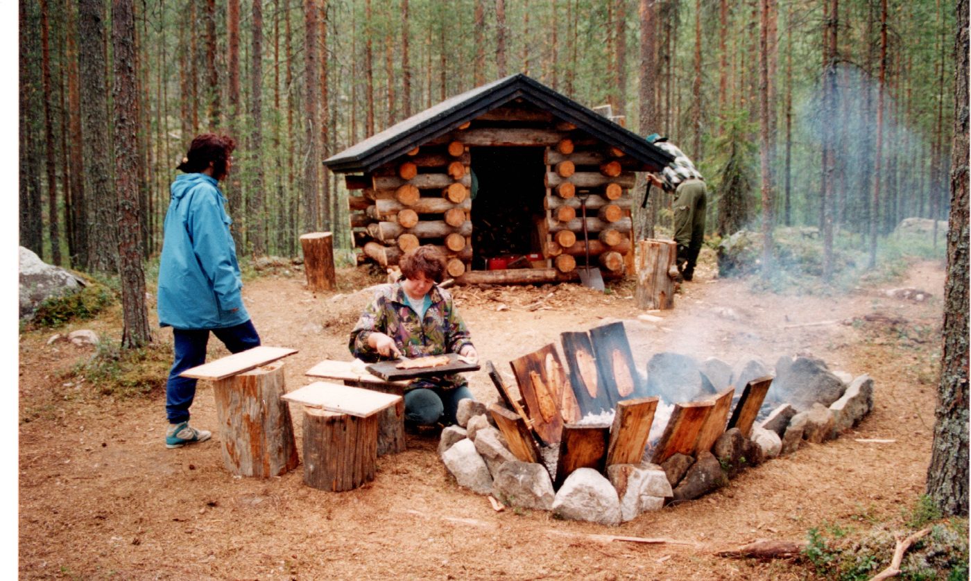 Salmon on planks by the campfire at the wilderness hut